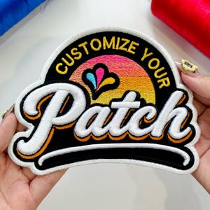 May include: Embroidered patch with the words "Customize Your Patch" in a retro font. The patch features a colorful sunset design with a black border and white and orange accents. The patch is held by a person.