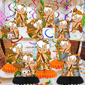 May include: A collection of Bamm-Bamm Rubble paper honeycomb centerpieces featuring the character with white hair, a leopard print outfit, and a wooden club. Some designs include the text Bamm-Bamm and various gym equipment like weights.