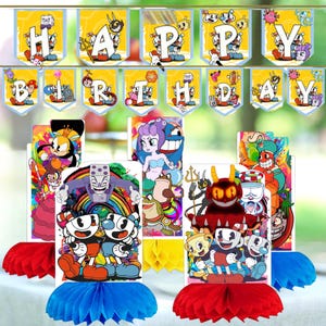 May include: A set of Cuphead-themed party decorations including a Happy Birthday banner with yellow pennants featuring cartoon characters and letters, and four vertical honeycomb centerpieces displaying various game characters in vibrant colors.