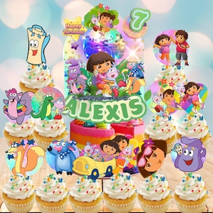 May include: A colorful birthday cake and cupcakes featuring Dora the Explorer characters. The cake has a rainbow design with the name "Alexis" and a "Happy Birthday" message. Cupcakes are topped with Dora and friends, perfect for a themed party.