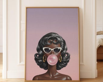May include: A framed art print featuring a stylized illustration of a woman with dark hair, white sunglasses, and gold hoop earrings blowing a bubblegum bubble. The background transitions from pink to purple.