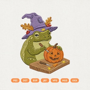May include: An embroidery design featuring a green frog wearing a purple witch hat with oak leaves and red berries. The frog uses a small knife to carve an orange jack-o'-lantern on a wooden cutting board. Text below includes PES, DST, EXP, JEF, VP3, HUS, XXX.