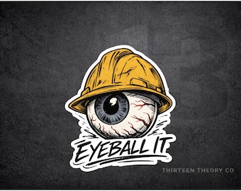 Könnte beinhalten: Aufkleber mit einer detaillierten Illustration eines Augapfels, der einen gelben Bauhelm trägt. Der Text "EYEBALL IT" befindet sich unter dem Auge, mit "THIRTEEN THEORY CO" am unteren Rand. Das Design ist vor einem dunkelgrauen Hintergrund.