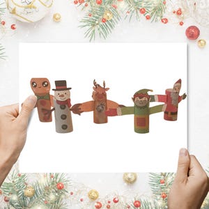 May include: Five handmade Christmas decorations made from cardboard tubes. The figures include a gingerbread man, snowman, reindeer, elf, and Santa Claus. Each has painted details and outstretched arms, ideal for festive displays during the holiday season.