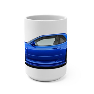 May include: A white ceramic mug featuring a vibrant blue sports car graphic wrapped around the center. The design showcases the side profile of the vehicle, including the door, window, and side mirror, set against a clean white background.