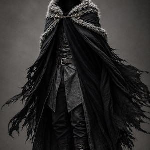 May include: A black hooded cloak with a faux fur trim and a metal chain clasp, worn over a dark textured tunic with a belt and matching trousers. The cloak features a distressed, frayed hemline, and the outfit is completed with black leather boots.