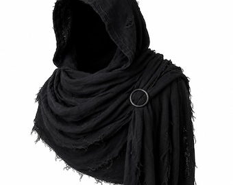 May include: A black hooded cowl made of lightweight, distressed fabric with frayed edges. The garment features a circular ring fastener that gathers the draped material at the shoulder, creating a layered, textured appearance around the neck and head.