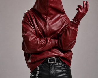 May include: A deep red hooded jacket with a full-face mask featuring two oval eye openings, paired with matching red gloves. The outfit includes black trousers with a silver belt buckle and a silver chain attached to the belt loop at the waist.