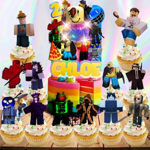May include: A colorful birthday cake with rainbow layers, topped with Roblox-themed figurines and cupcakes. The cake is decorated with the name "CHLOE" in yellow letters and a "2" candle. The cupcakes are decorated with sprinkles.