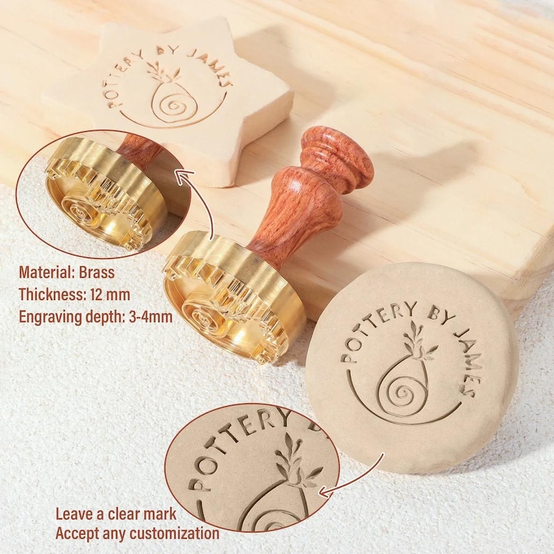 May include: A brass pottery stamp with a wooden handle, featuring a circular head with a spiral and leaf design and the text POTTERY BY JAMES. The stamp has a thickness of 12 mm and an engraving depth of 3-4 mm, shown creating impressions in clay.