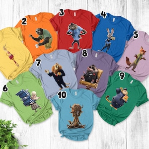 May include: A collection of ten short-sleeved crew neck t-shirts in various colors, each featuring a different animated character from the movie Zootopia. The shirts are numbered one through ten and display characters like Judy Hopps, Nick Wilde, Flash, and others.