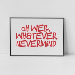 May include: A framed art print with the words "OH WELL, WHATEVER, NEVERMIND" in red, handwritten-style lettering. The print is set against a white background and enclosed in a black frame. The phrase is a popular saying.