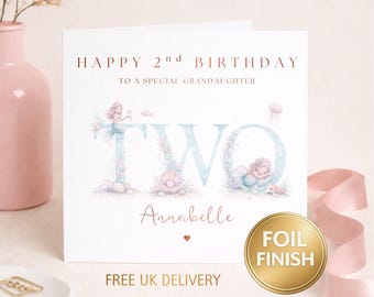 May include: A square birthday card with the text "HAPPY 2nd BIRTHDAY TO A SPECIAL GRANDDAUGHTER". The word "TWO" is in a light blue font with mermaid and seashell illustrations. The name "Annabelle" is written below the word "TWO". A gold foil finish sticker is on the right.