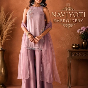 May include: A lavender sleeveless tunic with floral embroidery and pearl accents, paired with matching wide-leg trousers and a sheer organza dupatta. The garment features a scalloped hem with hanging beads and the text NAVJYOTI EMBROIDERY.