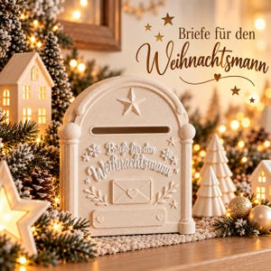May include: A cream-colored mailbox with an arched top, featuring a star, snowflake, and envelope with heart relief designs. The text "Briefe für den Weihnachtsmann" is embossed on the front. It has a horizontal slot for letters.