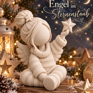 May include: A cream-colored figurine of an angel with a textured, ribbed sweater and pants, wearing a hair bun with a star accessory. The angel holds a five-pointed star in one hand. The text "Engel im Sternenstaub" is visible above the figure.