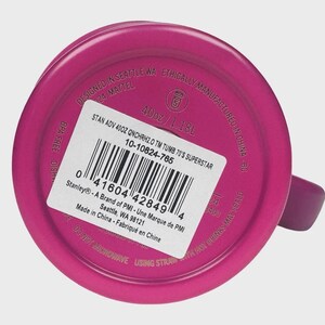 May include: A magenta-coloured tumbler with a handle. The base of the tumbler features a white sticker with product information, including the text "40oz / 1.18L" and "BPA FREE". The text "Designed in Seattle WA" is also visible.