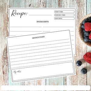 May include: Two white rectangular recipe cards with black text. The top card features fields for Recipe, Prep Time, Cooking Time, Servings, and Ingredients. The bottom card includes an Instructions section with lines and a My notes section.