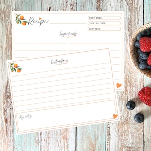 May include: Two rectangular recipe cards with orange borders and orange fruit illustrations. The top card features fields for Recipe, Prep Time, Cooking Time, Servings, and Ingredients. The bottom card includes an Instructions section and a My Notes box.
