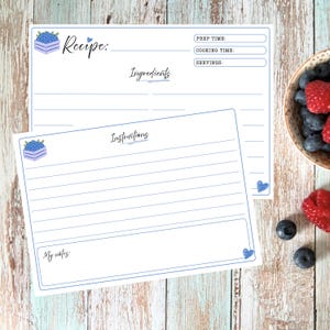 May include: Two white recipe cards with blue borders and blueberry crate illustrations. The top card features fields for Recipe, Prep Time, Cooking Time, Servings, and Ingredients. The bottom card includes an Instructions section and a My Notes box.