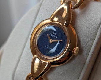 Precioso reloj vintage para mujer en tono dorado con esfera azul.
