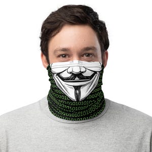 May include: A black and white face covering featuring the Guy Fawkes mask design. The mask is white with black outlines and details. The lower portion of the face covering has a black background with green binary code.