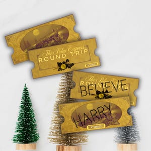 May include: Gold-colored Polar Express round trip tickets with a train illustration. The tickets have the words "ROUND TRIP" and "BELIEVE" printed on them. The tickets are decorated with holly and berries and the name "HARRY" is printed on one of the tickets.