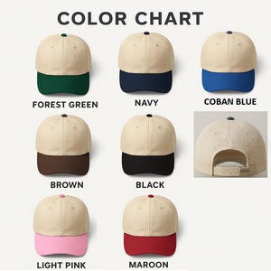 May include: A color chart displaying seven baseball caps with beige crowns and contrasting brims in forest green, navy, coban blue, brown, black, light pink, and maroon. One cap shows the back view with an adjustable strap and metal buckle.