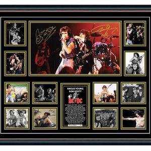 May include: A framed AC/DC band collage, featuring multiple images of the band performing live, including a central photo. The collage includes signatures and a small informational text about Angus Young and Bon Scott.