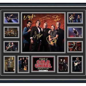 May include: A framed collage of a band, featuring multiple photographs of the band members and live performances. The central image shows the band posing with signatures. The bottom centre image has the text "The Big Five-O Cold Chisel The 50th Anniversary Tour".