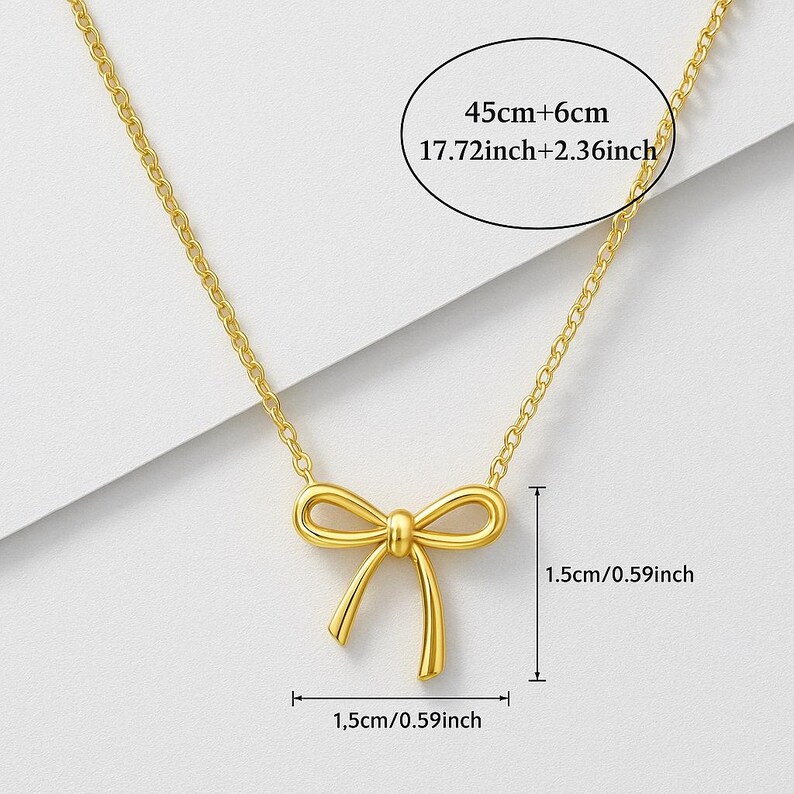 May include: A gold-colored necklace featuring a bow pendant. The chain measures 45cm + 6cm (17.72 inches + 2.36 inches). The bow pendant is 1.5cm (0.59 inches) wide and 1.5cm (0.59 inches) high.
