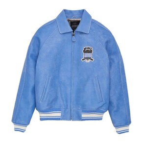 May include: A light blue jacket with a full-length front zipper, a pointed collar, and long sleeves. The garment features a white and blue striped ribbed hem and cuffs, two side pockets, and an embroidered patch on the chest reading AVIREX.