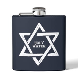 May include: A navy blue hip flask with a silver cap and hinge. It displays a white Star of David and the words "HOLY WATER". The flask is rectangular and has a smooth finish.
