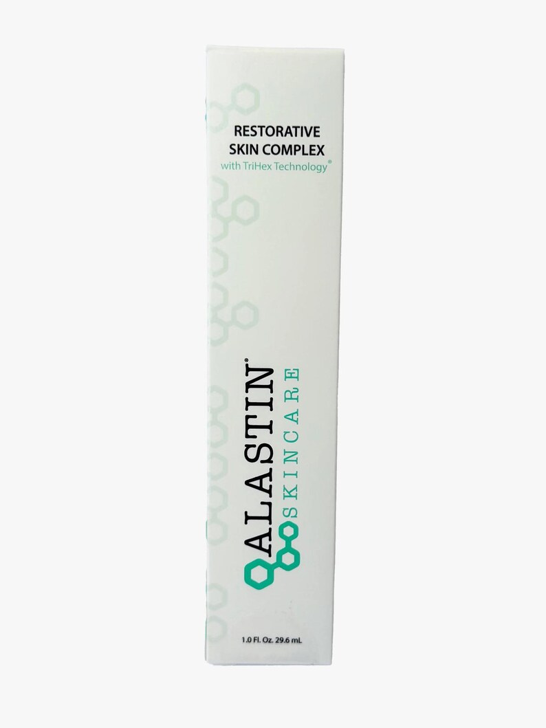May include: A white skincare product box with the text "ALASTIN SKINCARE" in teal and the words "RESTORATIVE SKIN COMPLEX" in black. The box contains 1.0 fl. oz. or 29.6 mL of product and features a geometric design.