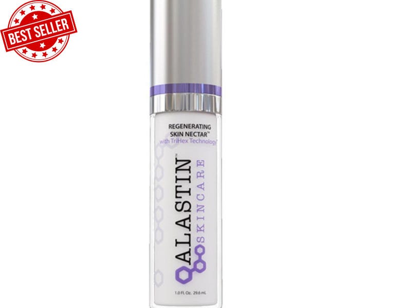 May include: A white and silver skincare product bottle with the text "ALASTIN SKINCARE" and "Regenerating Skin Nectar". The bottle has a purple accent and a silver cap. A "BEST SELLER" sticker is in the upper left corner. The bottle contains 1.0 fl oz, or 29.6 ml.