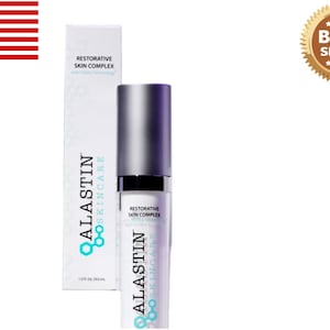May include: A skincare product with a silver cap and a white and purple label. The product is labeled "Restorative Skin Complex" and "Alastin Skincare". The packaging includes a box with the same branding and text. A "Best Seller" seal is in the upper right corner.
