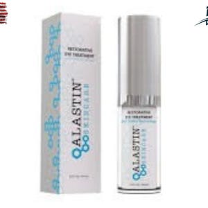 May include: A white box and a cylindrical bottle of Alastin Skincare Restorative Eye Treatment. The box has blue decorative elements and the brand name. The bottle has a silver cap and the product name is visible.