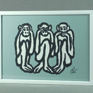 May include: A framed print of three monkeys, each covering a different part of their face. The monkey on the left is covering its ears, the monkey in the middle is covering its eyes, and the monkey on the right is covering its mouth. The monkeys are drawn in a black and white style on a light blue background. The print is signed "Chet".