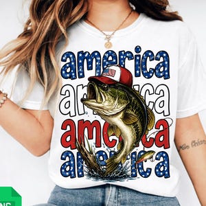 May include: White t-shirt featuring a graphic of a largemouth bass wearing a red, white, and blue hat. The word "America" is stacked vertically in red, white, and blue, with a patriotic theme.