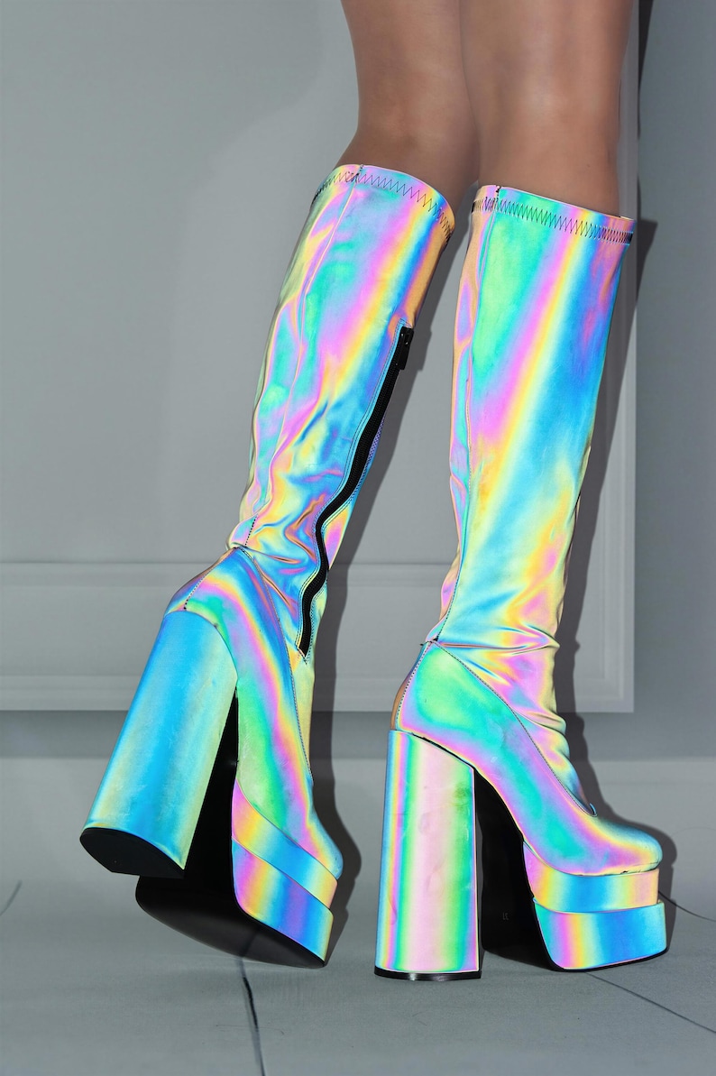 A pair of colorful, rainbow-colored platform boots with a high platform and thin heels.