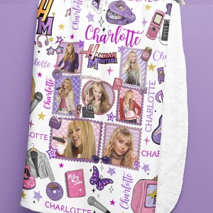 May include: White fleece blanket featuring a collage of images and text related to the character Hannah Montana. The design includes photos, stars, and the name "Charlotte" in various fonts and colors. A pink television and a butterfly are also visible.