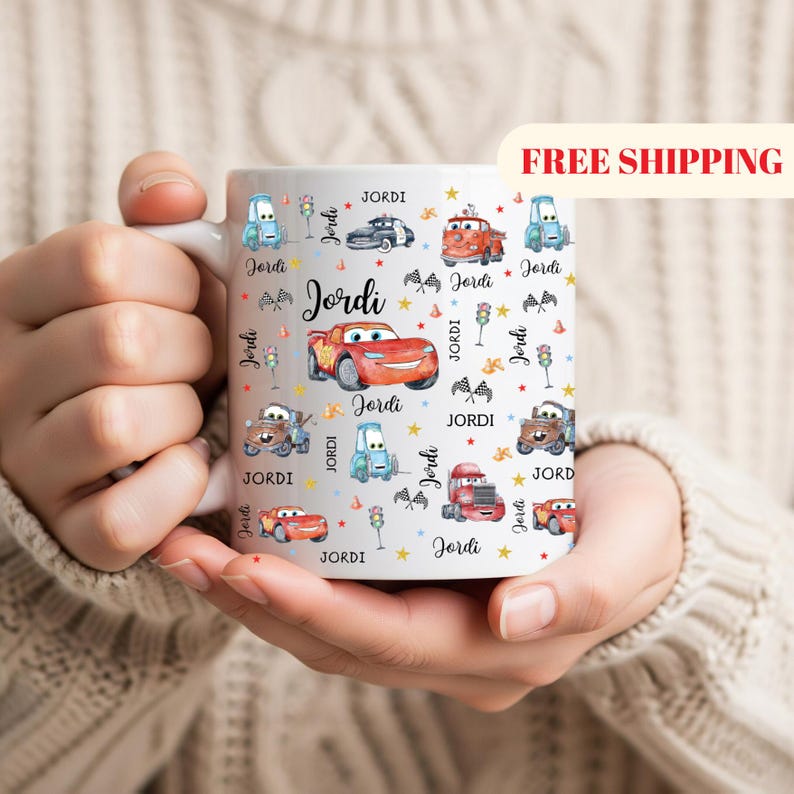 May include: White ceramic mug featuring a colorful car-themed design with the name "Jordi" repeated throughout. The mug showcases various cartoon cars, stars, and traffic lights. A perfect gift for car enthusiasts.