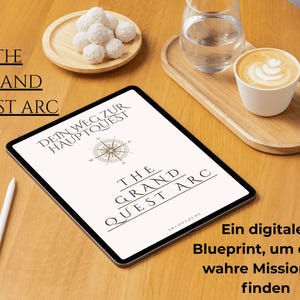 May include: A digital tablet displaying "THE GRAND QUEST ARC" with a compass graphic. A white stylus, a cup of coffee, a glass of water, and a plate of white treats are on a wooden table. Text reads "A digital Blueprint, to find your true Mission."