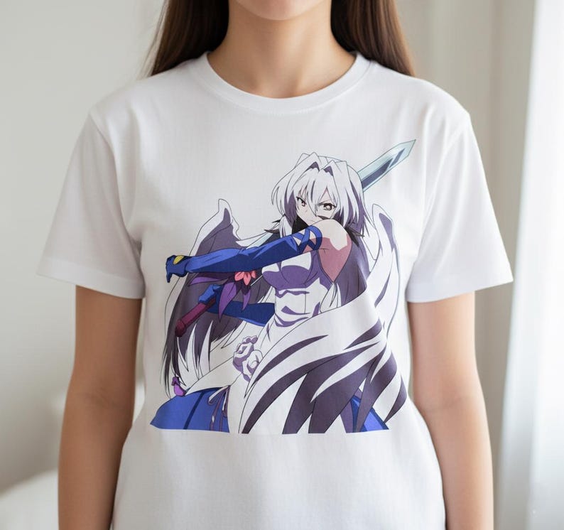 May include: White t-shirt featuring a colorful anime illustration of a female character with white hair, wings, and a sword. The character is wearing blue and purple clothing. The graphic is centered on the shirt.