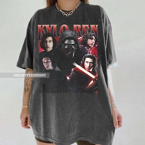 May include: Dark gray t-shirt featuring a graphic of Kylo Ren and other characters from the Star Wars film series. The text "KYLO REN" is printed in red at the top. The shirt has a vintage, worn look.