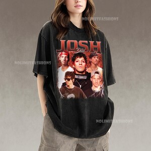 May include: Black t-shirt featuring a graphic of the band members with the text "JOSH DUN" in red. The shirt has a vintage, distressed look. The band members are in a collage-style design.