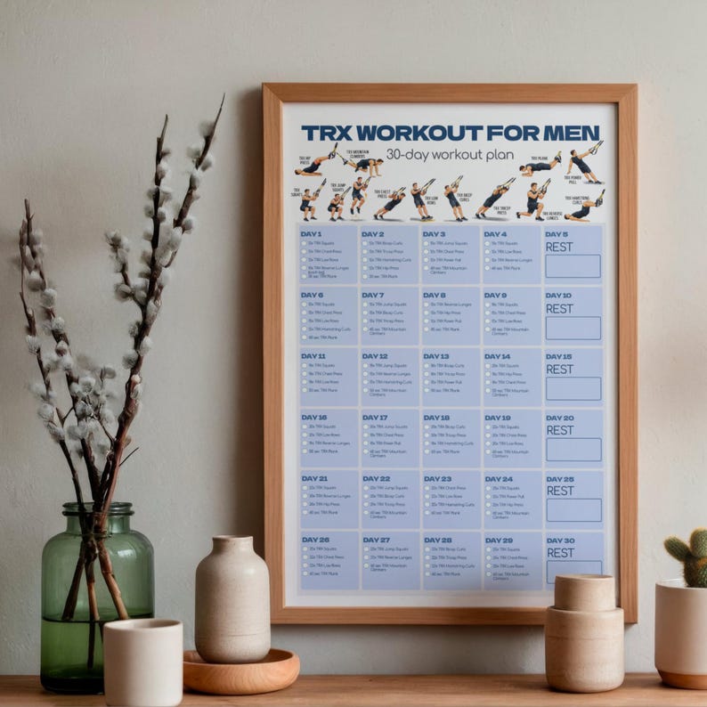 May include: A framed 30-day TRX workout plan poster with blue text and a grid layout. The top section features illustrations of individuals performing various exercises. The text reads TRX WORKOUT FOR MEN 30-day workout plan, followed by a daily schedule.