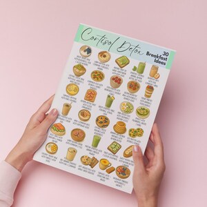 K&ouml;nnte beinhalten: Ein Set aus drei Keramikbechern mit einer gesprenkelten, cremefarbenen Glasur. Jeder Becher hat ein anderes handgemaltes Design: ein blaues und gr&uuml;nes Blatt, eine gelbe Blume und eine rote Beere. Die Becher haben eine einfache, abgerundete Form.