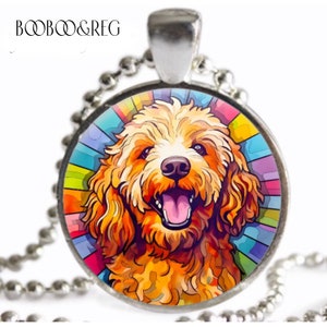 May include: A silver pendant necklace featuring a colorful, artistic rendering of a smiling dog. The dog has golden fur and a pink tongue, set against a vibrant, multi-colored background. The necklace has a ball chain.