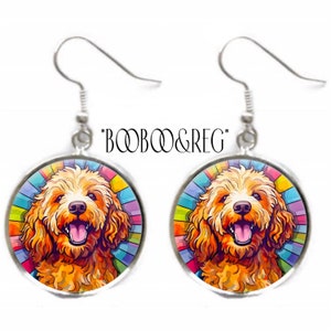 May include: A pair of silver dangle earrings featuring a colorful, cartoon-style illustration of a golden doodle dog with a rainbow background. The earrings are labeled "BOOBOO&REG*"